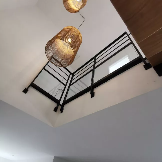 Escalier double limons central crémaillères, 1/4 tournant inversé, laquage ral 9005 FT, garde corps en acier, cadre 40x20, 2 lisses tube D.13, soubassement en vitrage fixé dans une cornière/pare close. 35133 JAVENE